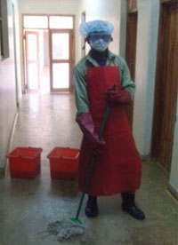 A cleaner wearing personal protective equipment (PPE).