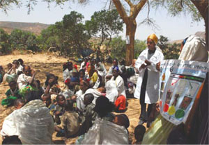 A health worker teaching mothers the community