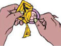 A condom being removed from the wrapper.