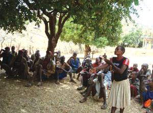 A Health Extension Practitioner presenting information to the community.