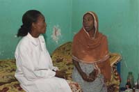 A HEP talks to a pregnant woman in her home about health issues.