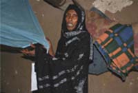 A woman puts up her insecticide treated bed net.