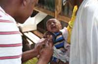 A baby crying out as it is immunized.