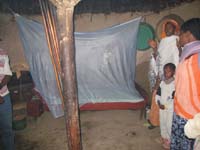A bed net is fixed up in a bedroom.