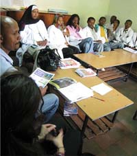 Healthcare workers are gathered in a classroom.