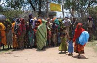 A group of women gather together to collect bed nets.