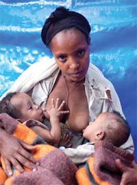A woman breastfeeding twins.