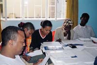 Health workers are sitting in a classroom interpreting data collected together.