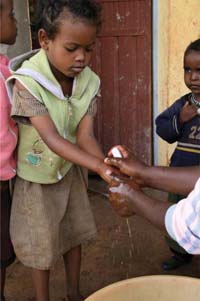 A child is shown how to correctly wash their hands.