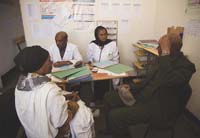 Health workers meet with significant people from the community in their office.