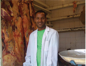 Butcher wearing a clean, white gown