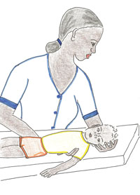 A child lays flat on a bed whilst the Health worker checks the child’s neck movements.