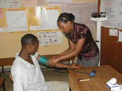 A healthworker measuring blood pressure