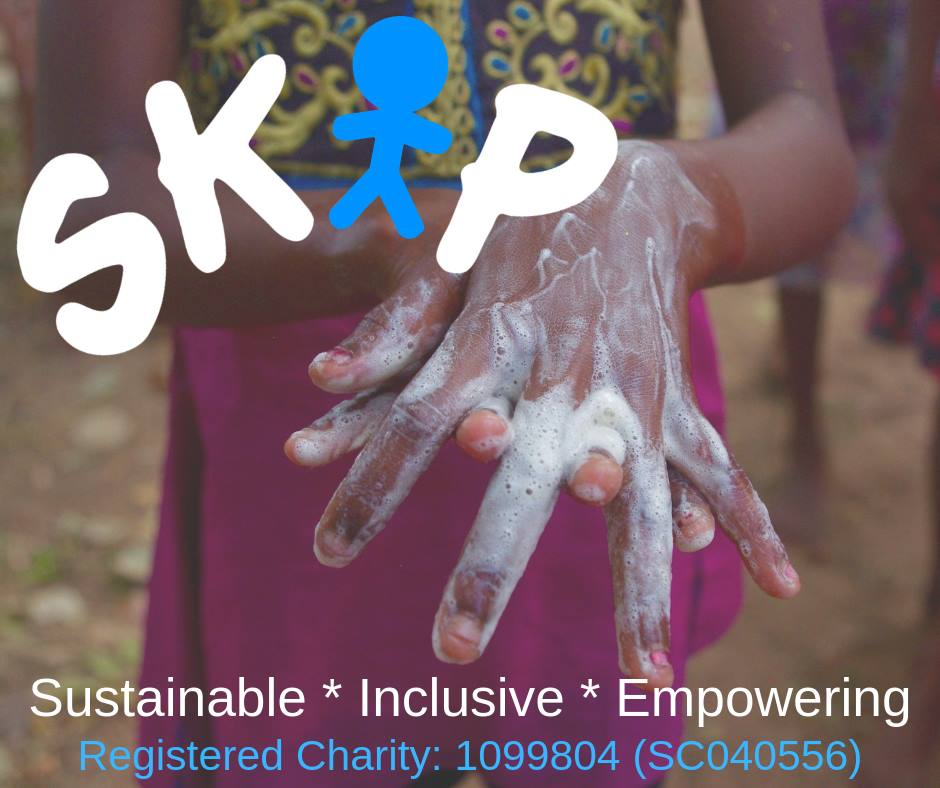 A child dressed in a black and yellow embroided top is washing their hands with soap. The SKIP logo and charity number is dis