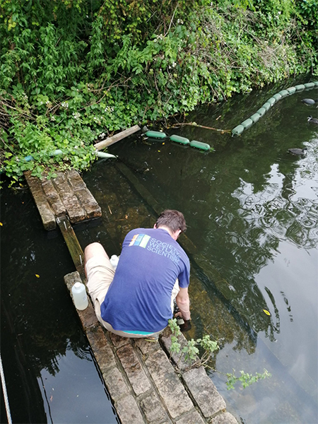 Photo of someone collecting a water sample