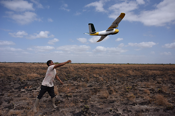 A photo of someone launching a fixed wing drone