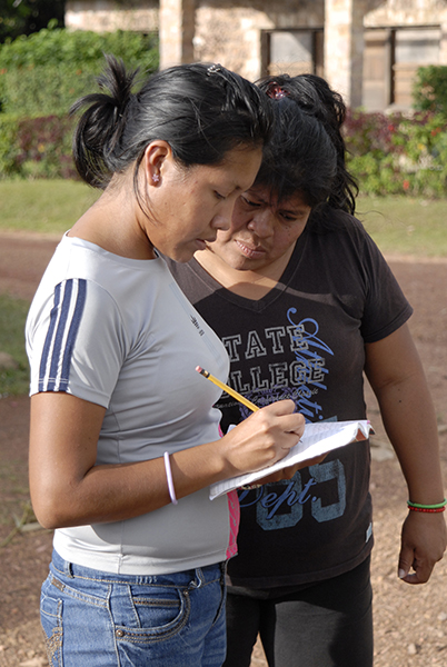 Two people looking at a form they are filling in where they are evaluating something