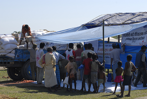 People queueing to collect food parcels distributed by an aid agency
