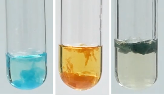 Test tubes containing precipitates of different metal hydroxides.