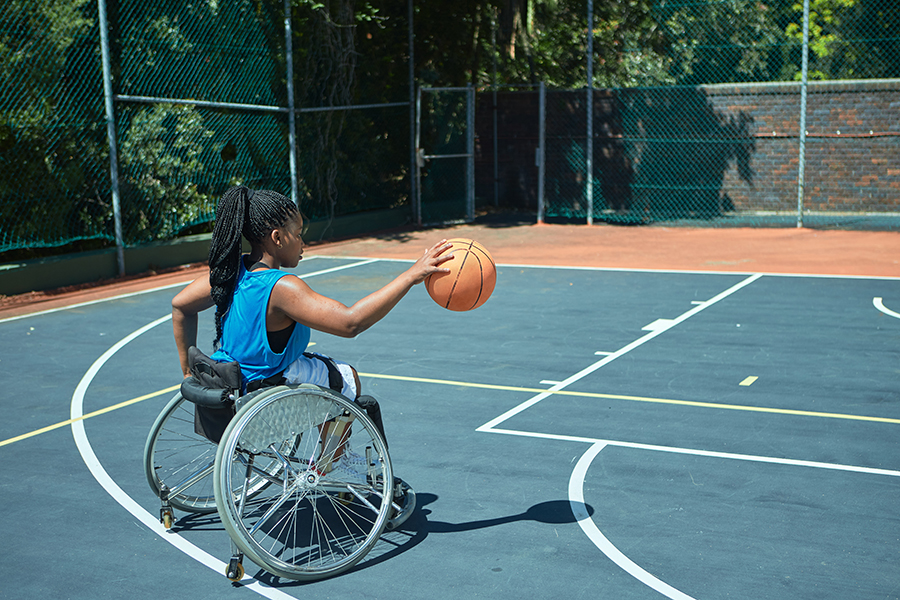 An image of a disabled, teenage girl in a wheelchair.