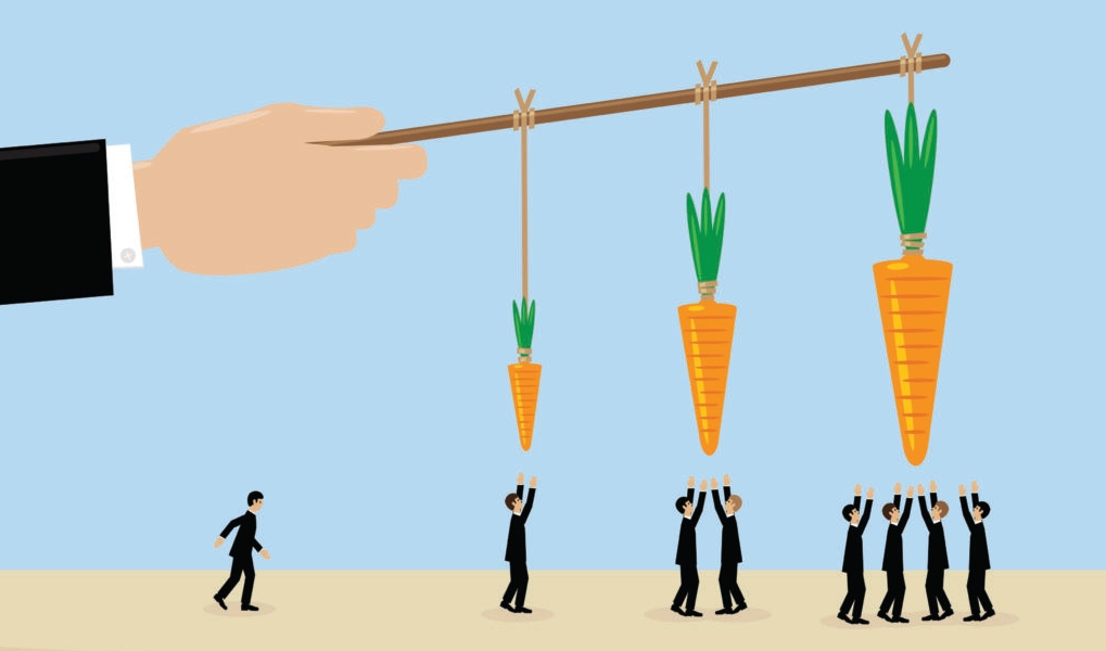 image of a man's  holding a stick on which carrots of various sizes are dangled ontop of persons trying to reach the carrots 