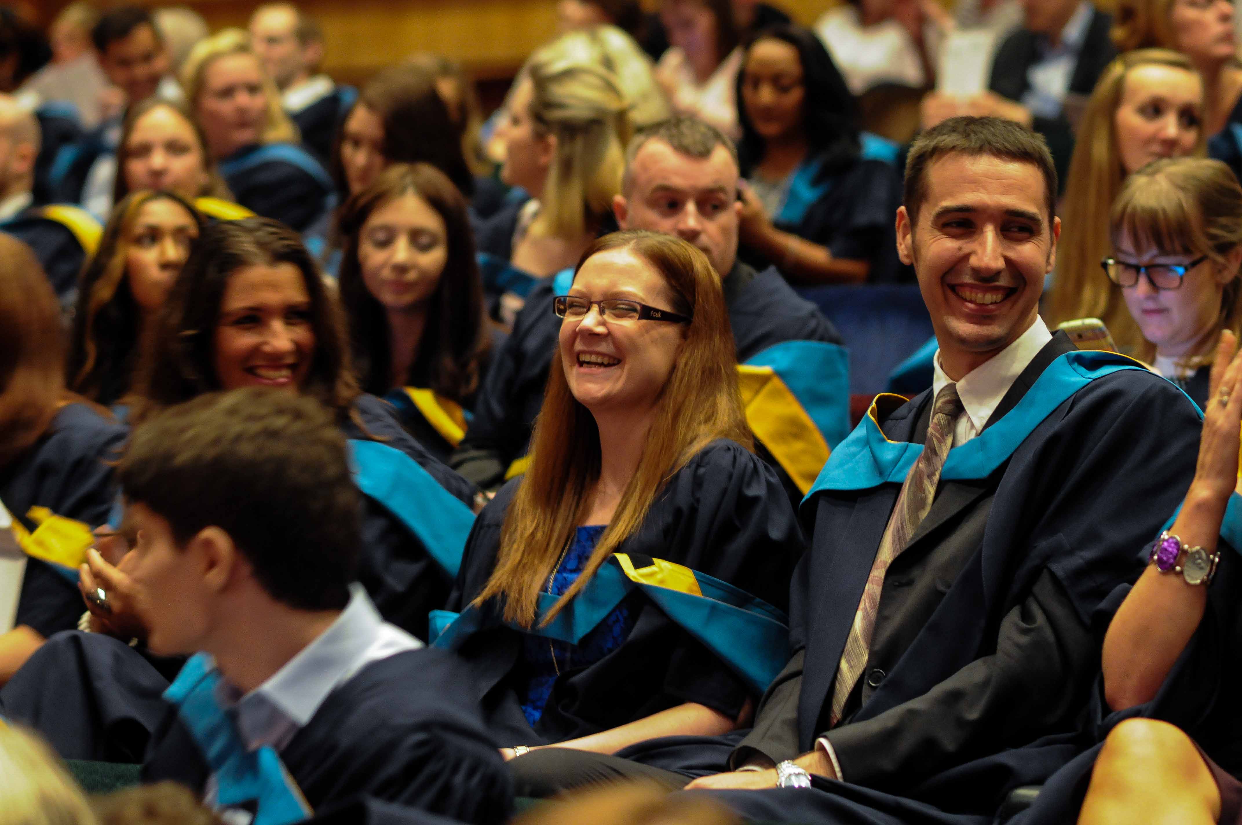 Image of a group of graduates laughing during a graduation ceremony