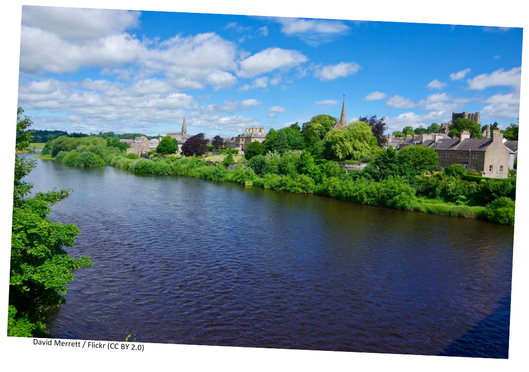A river in Kelso, Scotland on a bright summer day.