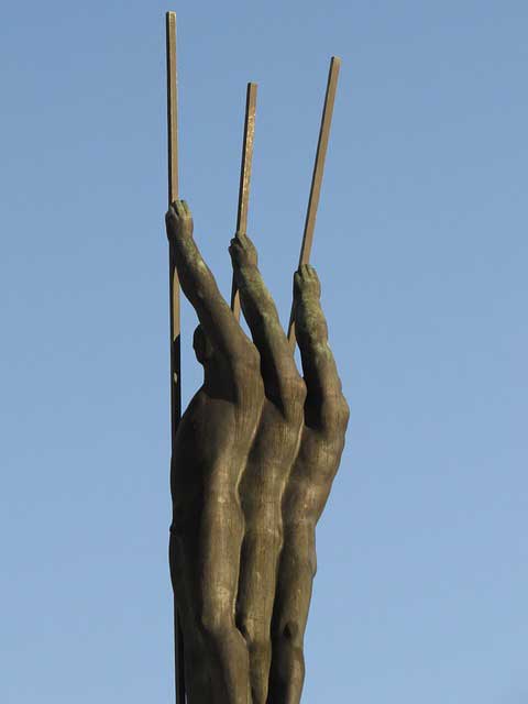 A huge bronze statue of fingers pointing upwards.