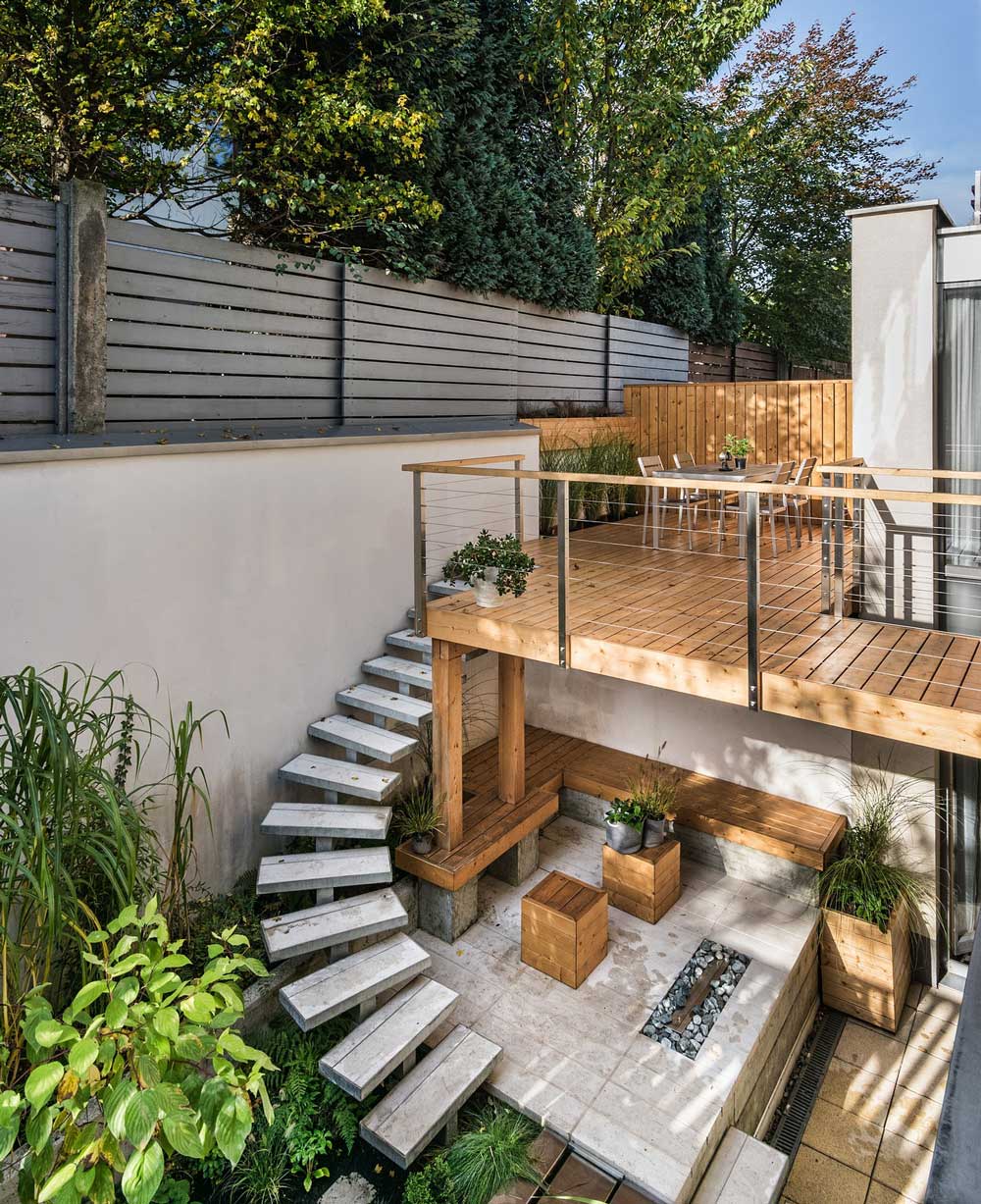 Another high view of sunken patio garden showing curved staircase leading from one level to another.