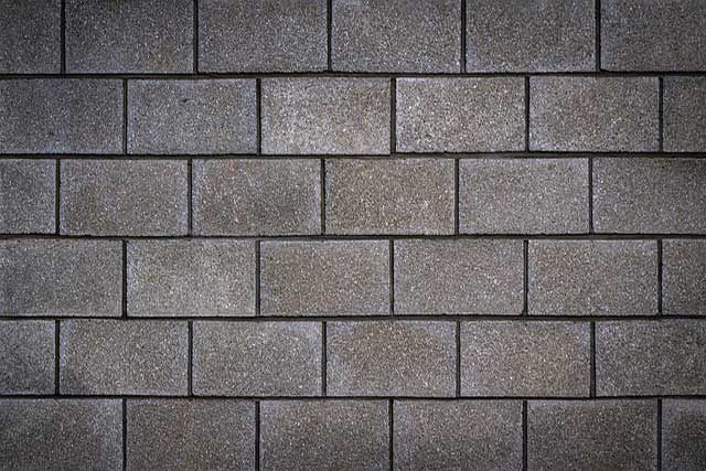 A wall made up of concrete blocks in standard brickwork style.