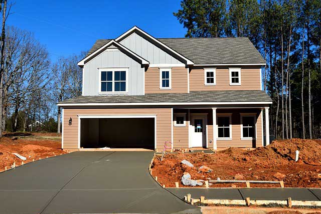 A new build house with a tarmac driveway.