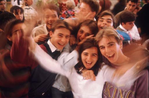 Group of young people laughing and waving hands