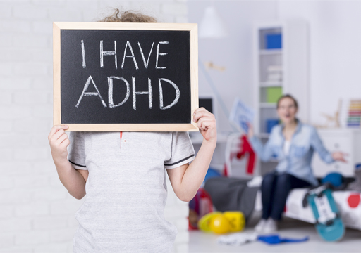 This is a photograph of a child holding a sign saying ‘I have ADHD’.