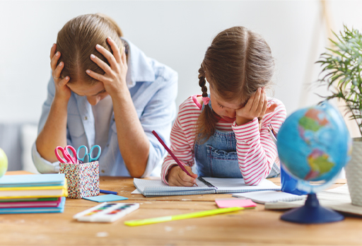 This is a photograph of a woman and a child. The woman has her head in her hands.