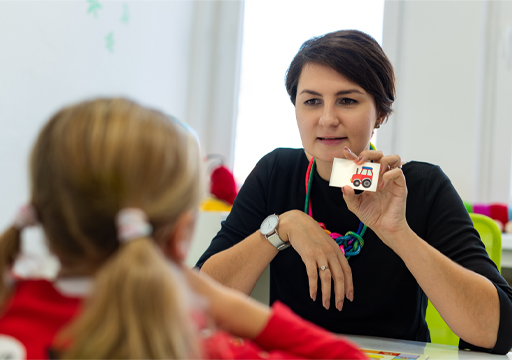 This is a photograph of a Teaching assistant working with a child.
