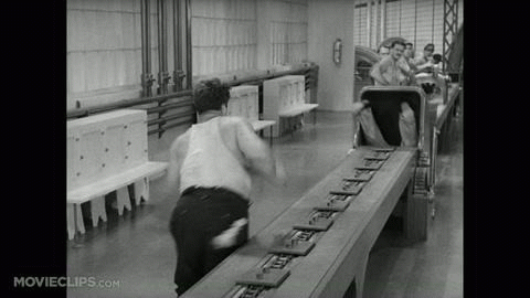 Assembly line scene from Charlie Chaplin's movie, "Modern Times." It is in the public domain. 
