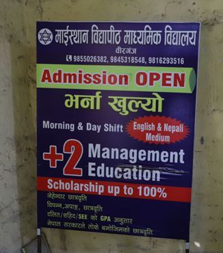 A sign on a wall in English and Nepali advertising admission open for school courses