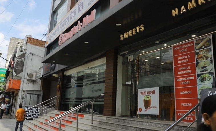 The front of a dessert shop in Nepal with English and local language on the signs