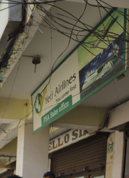 A shop sign in Nepal for an airline written in English