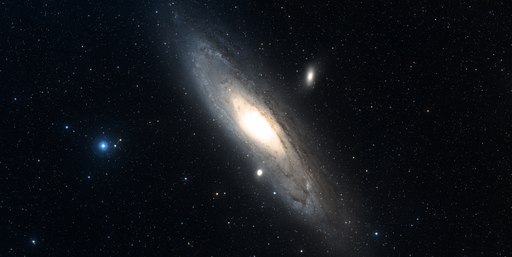 The image shows a distant galaxy, surrounded by stars.