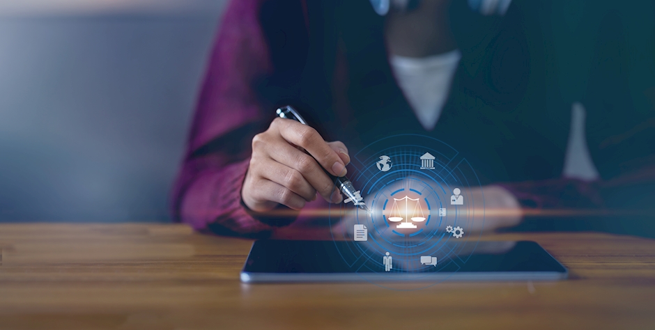 An image of a tablet projecting a digital hologram of law and compliance.