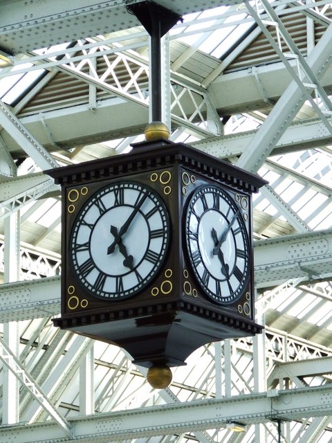 A large clock, with four faces, hanging in Glasgow Central Station.