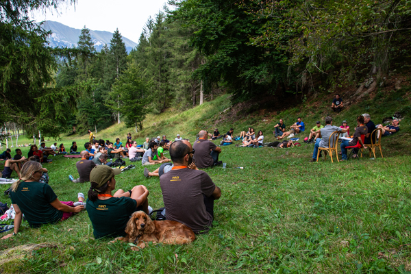 A group of people sitting on the grass at the coexistence festival