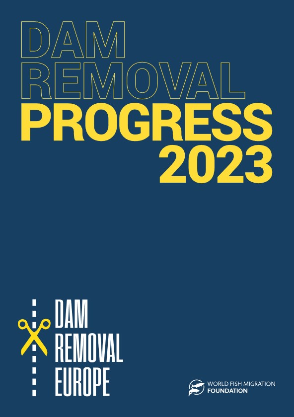 The image is a cover page titled 'Dam Removal Progress 2023.' It features bold text in blue and yellow on a dark blue background. The title 'DAM REMOVAL PROGRESS 2023' is prominently displayed at the top. Below, there is an icon of scissors cutting a dashed line next to the text 'DAM REMOVAL EUROPE.' In the bottom right corner, there is the logo of the World Fish Migration Foundation.