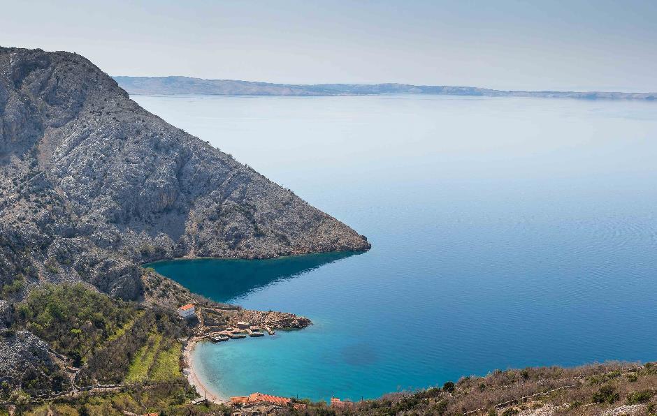 A landscape looking out over a bay towards the sea.