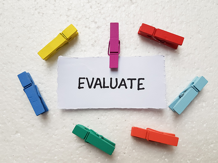 A piece of paper with typed lines on it. The typed text has been amended by hand with a red pen.