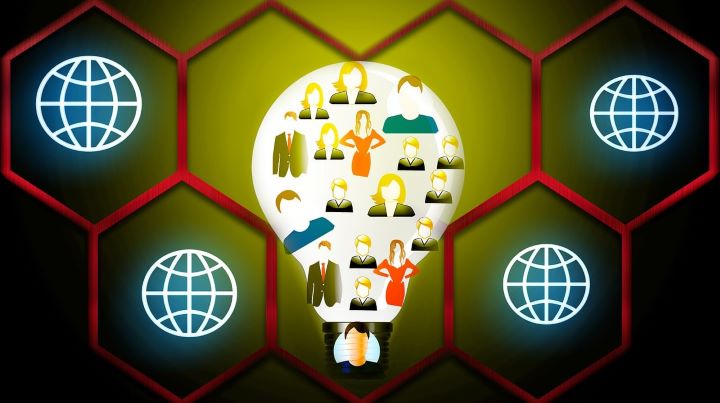 A lightbulb with icons of people inside it. The lightbulb is inside a cellular honeycomb with internet icons.
