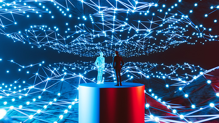 The image depicts an abstract digital scene. In the foreground, there is a cylindrical pedestal with two human figures standing on top—one appears to be a real human figure while the other is a translucent, holographic representation. Around them, a network of interconnected glowing blue dots and lines extends outward in all directions, forming a complex, web-like structure against a dark background.