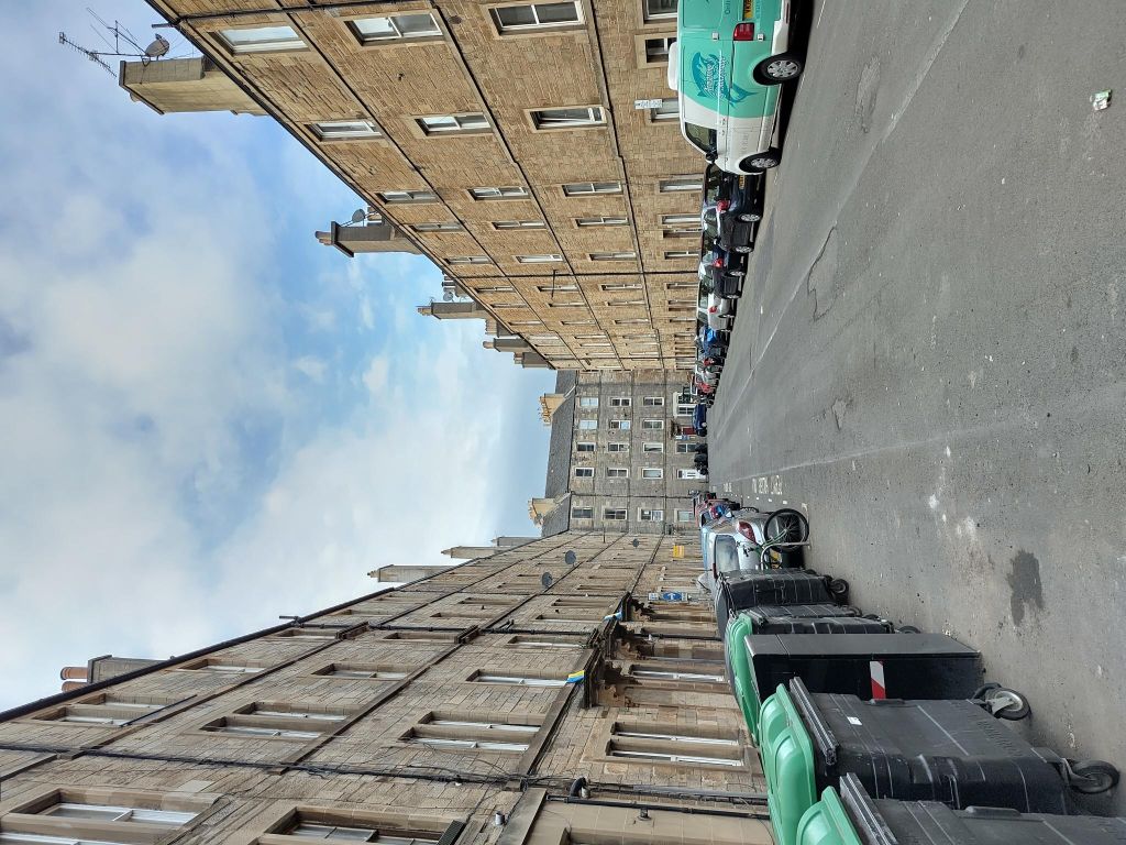 Victorian 4-floor tenements, with car parking, street bins and no trees. The view is quite stark