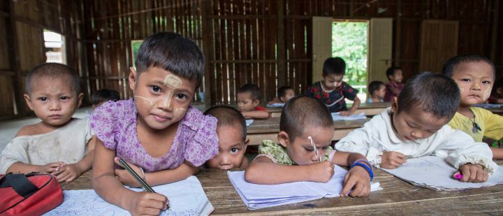 Young children in a schoolhouse in a rural area.